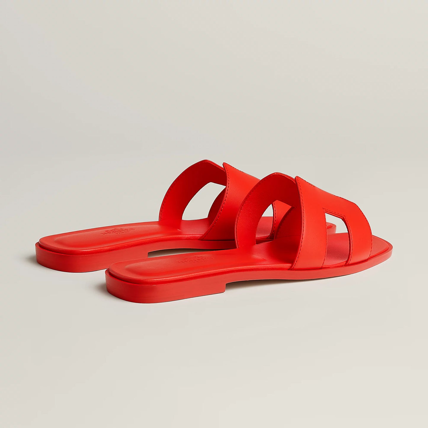Hermès Oran slide sandal, red leather, open square toe strap detail, flat red sole