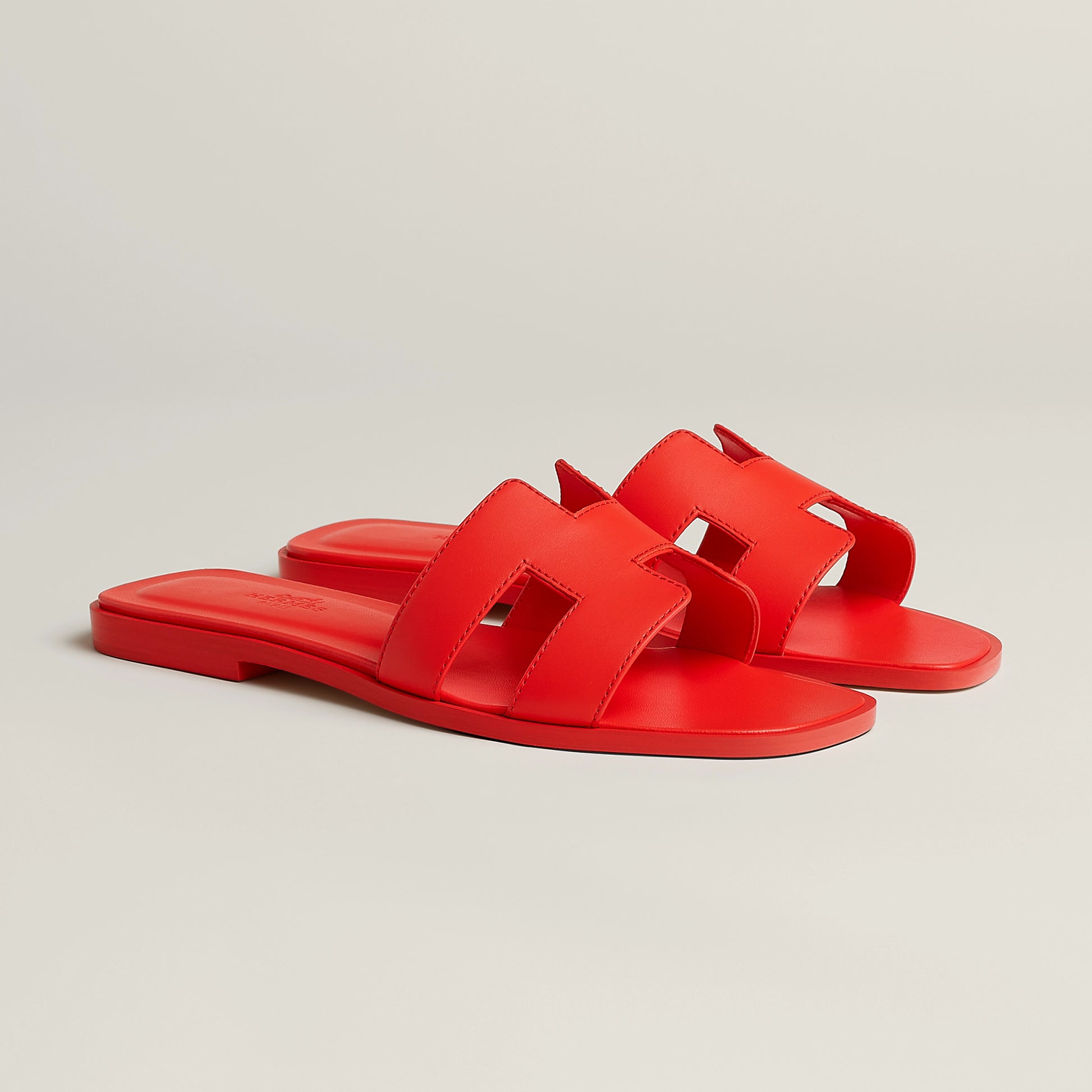 Hermès Oran slide sandal, bright red leather, open square toe, flat red sole
