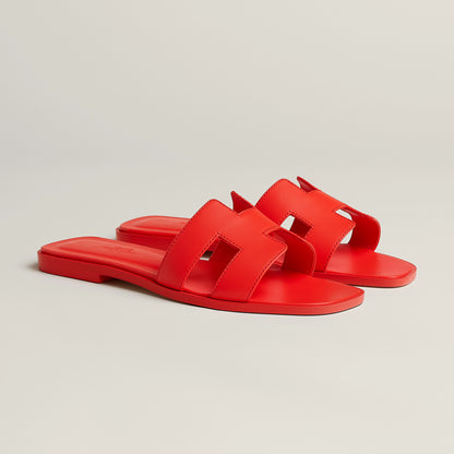 Hermès Oran slide sandal, bright red leather, open square toe, flat red sole