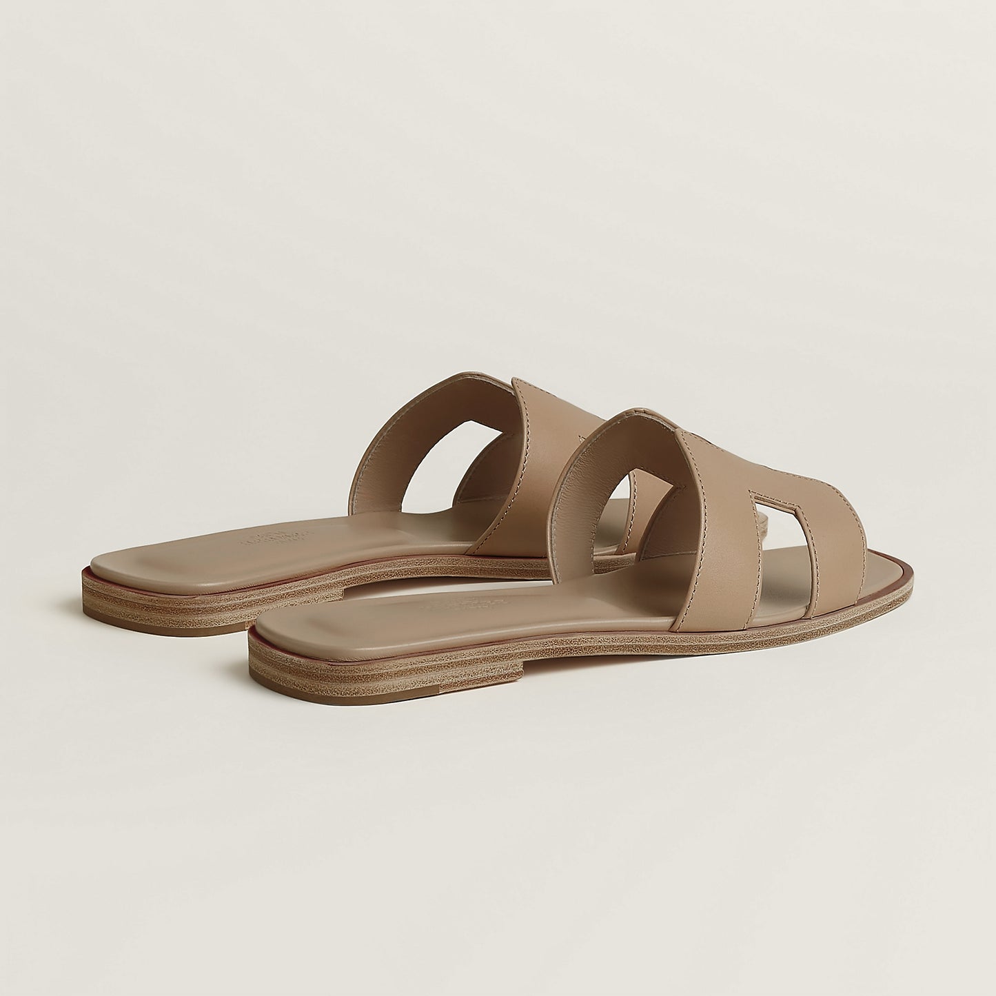 Hermès Oran slide sandal pair, light tan leather, open square toe, flat brown sole