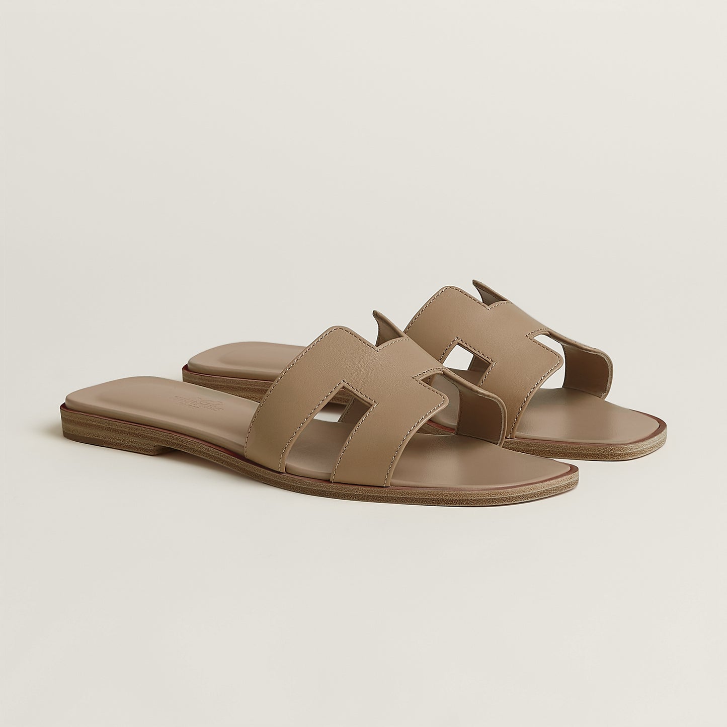 Hermès Oran slide sandal, beige/taupe leather, open square toe, flat brown sole
