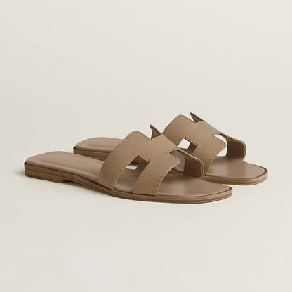 Hermès Oran slide sandal, beige/taupe leather, open square toe, flat brown sole