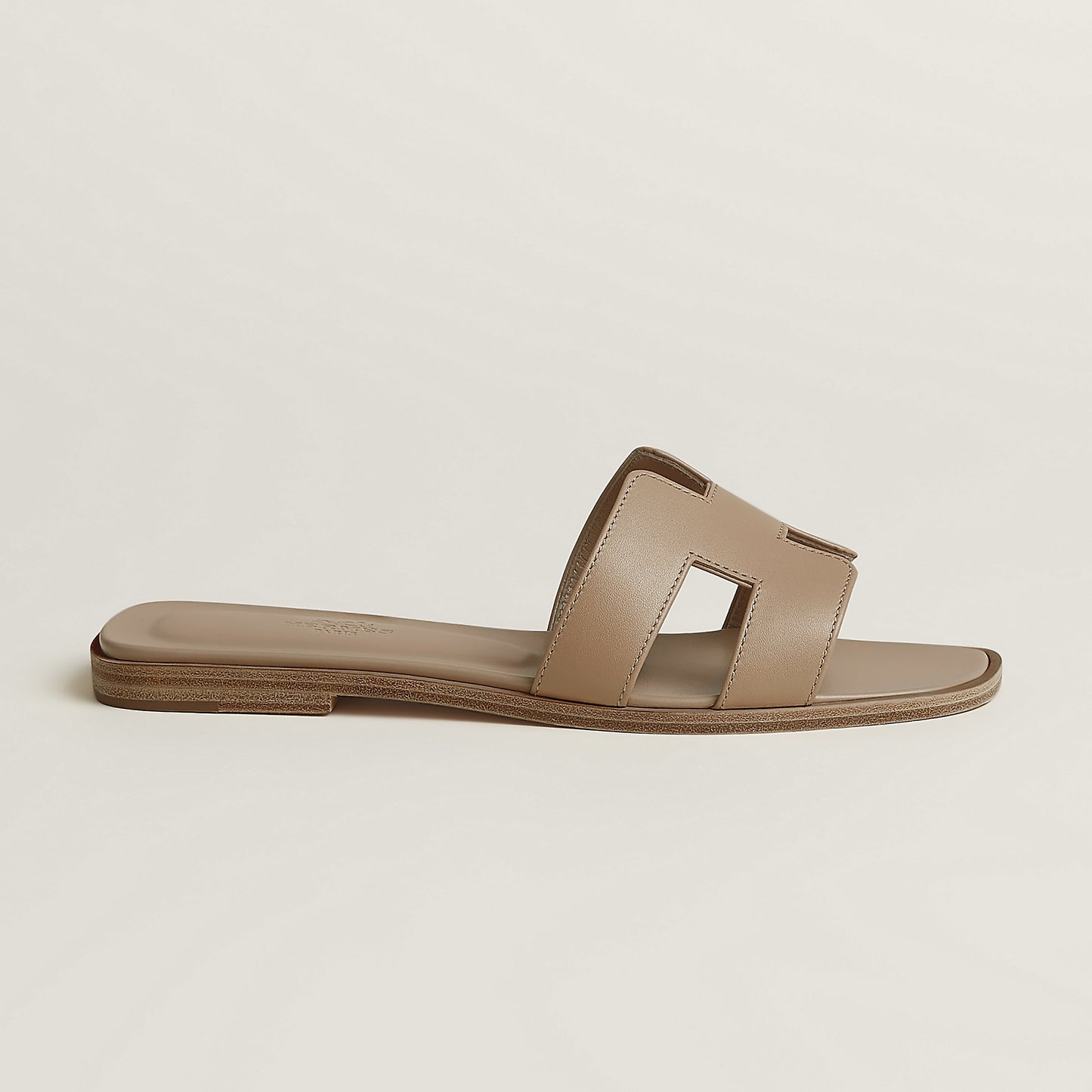 Hermès Oran slide sandal, light beige leather, open square toe, flat brown sole