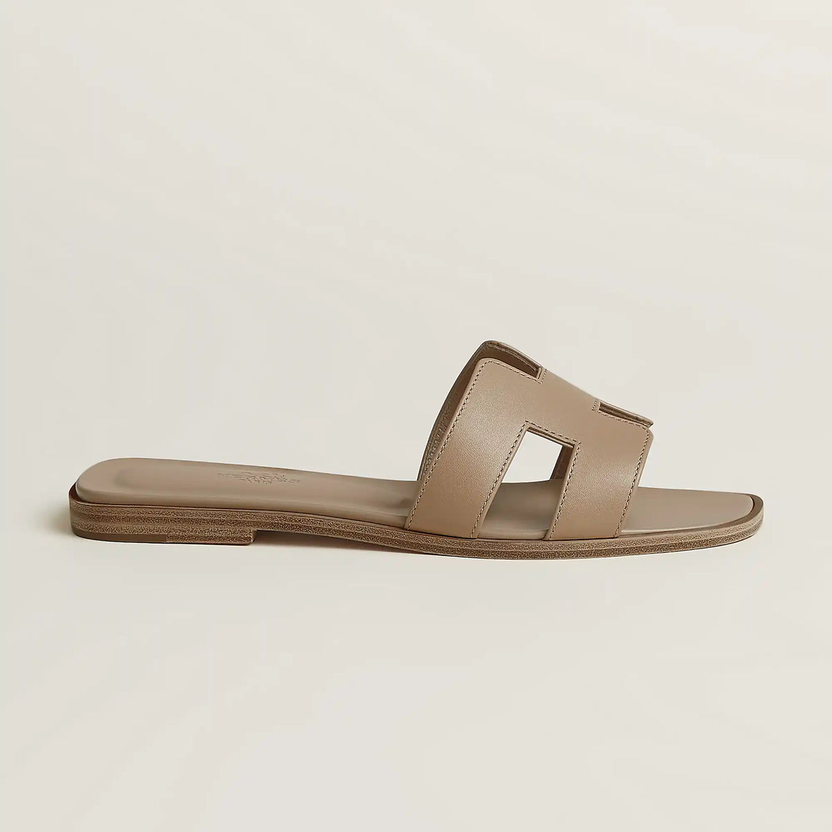 Hermès Oran slide sandal, light beige leather, open square toe, flat brown sole