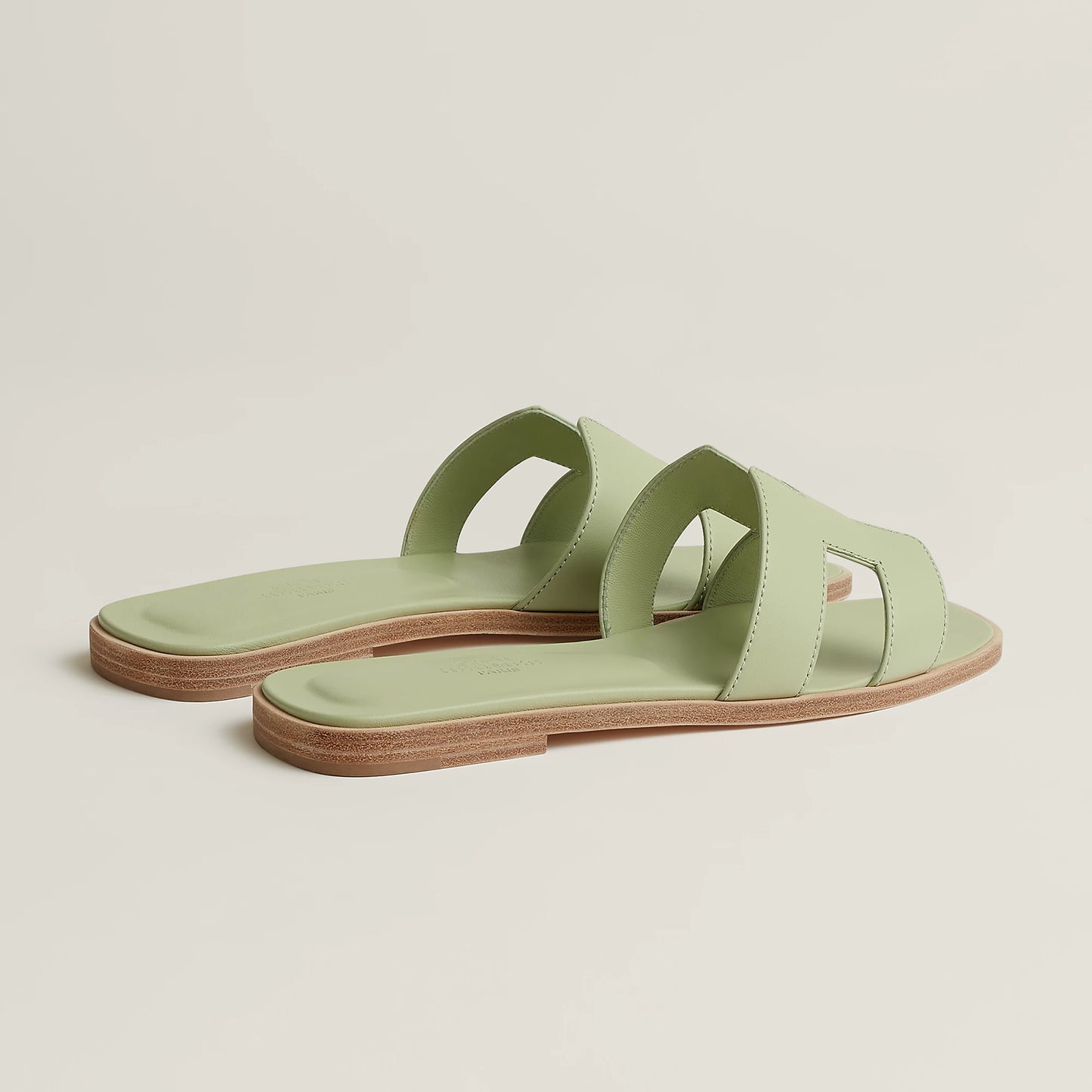 Oran slide sandal pair view in pale mint leather with double strap cutouts