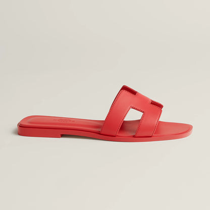 Hermès Oran slide sandal in bright red leather with double strap cutouts