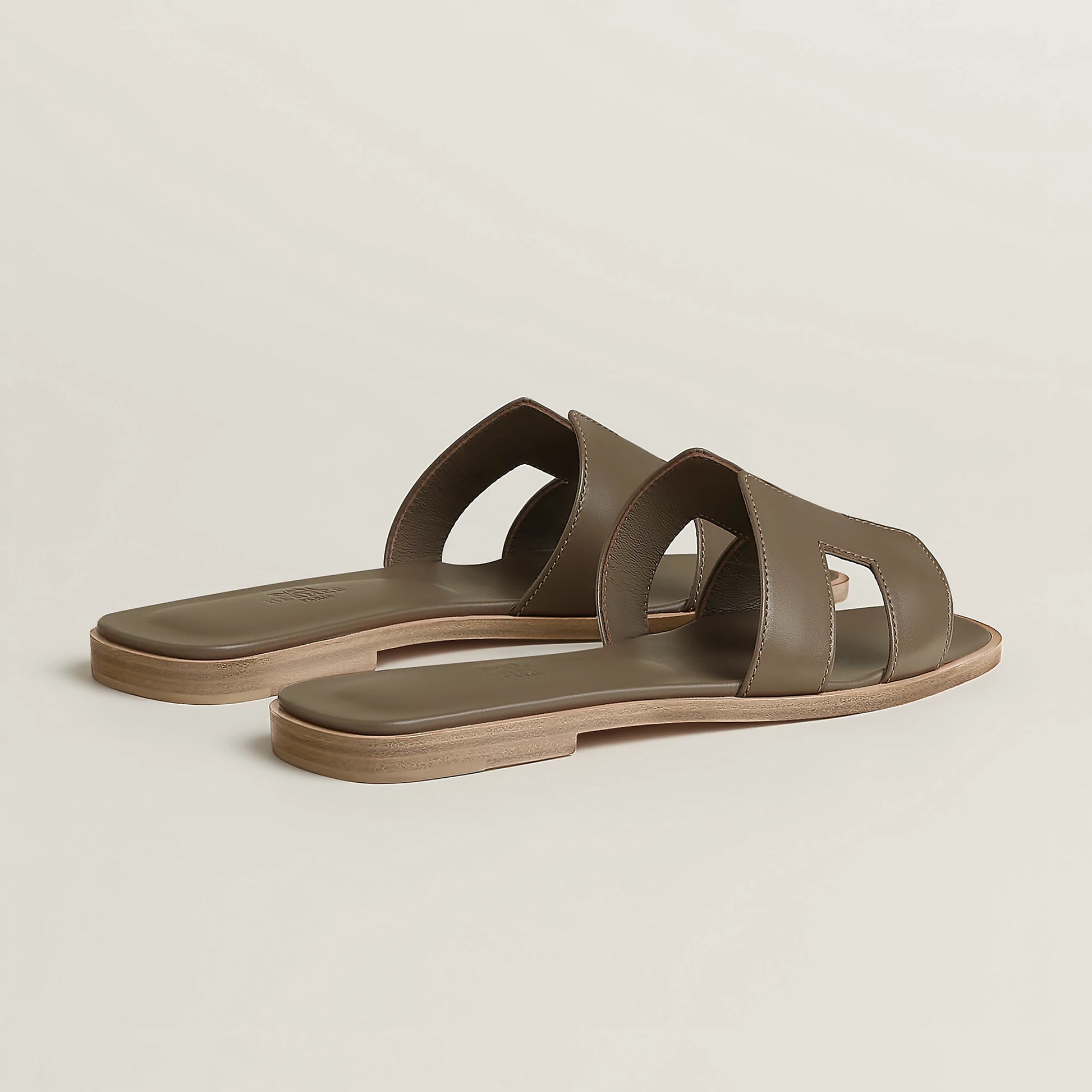 Taupe leather slide sandal with double strap cutouts and low flat sole