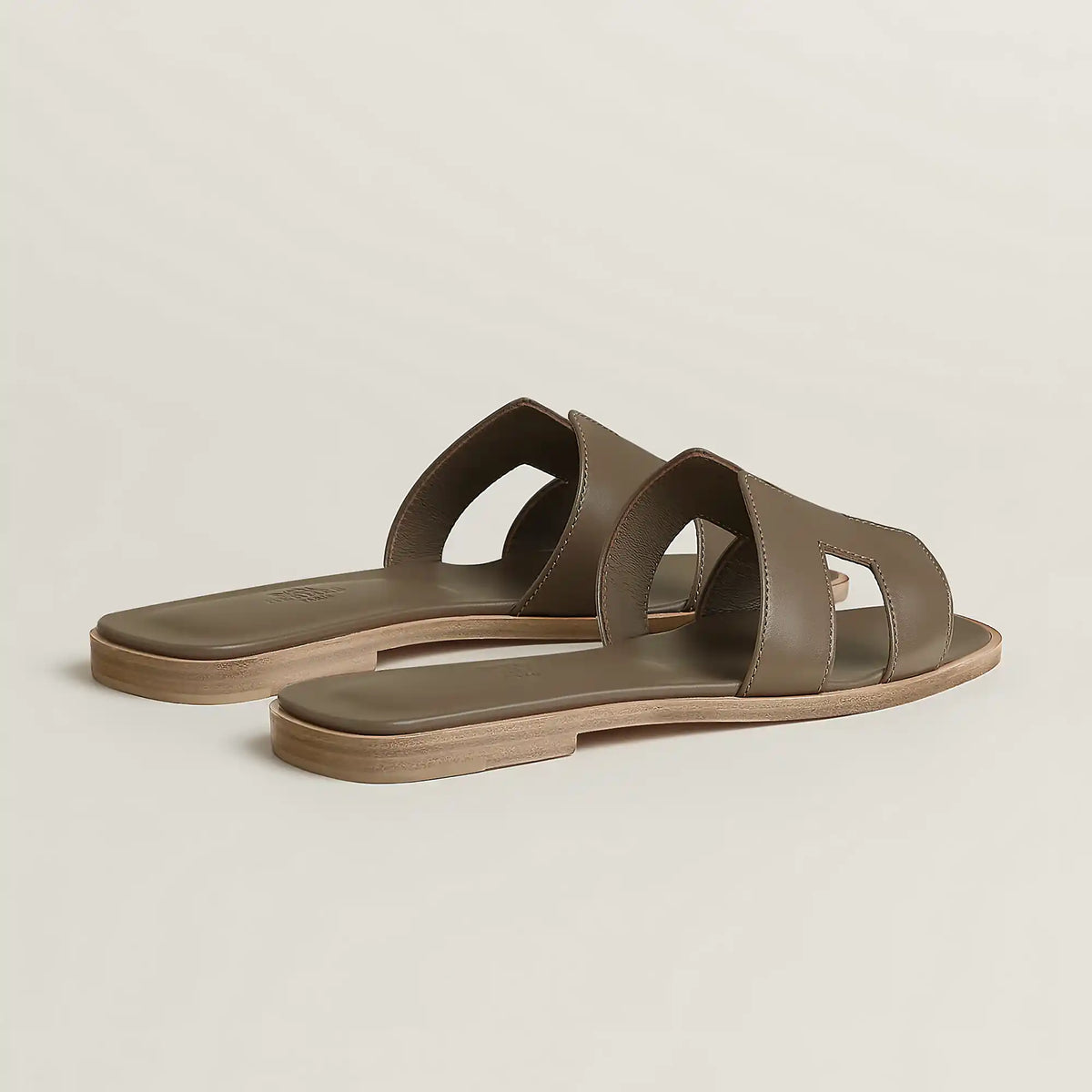 Taupe leather slide sandal with double strap cutouts and low flat sole
