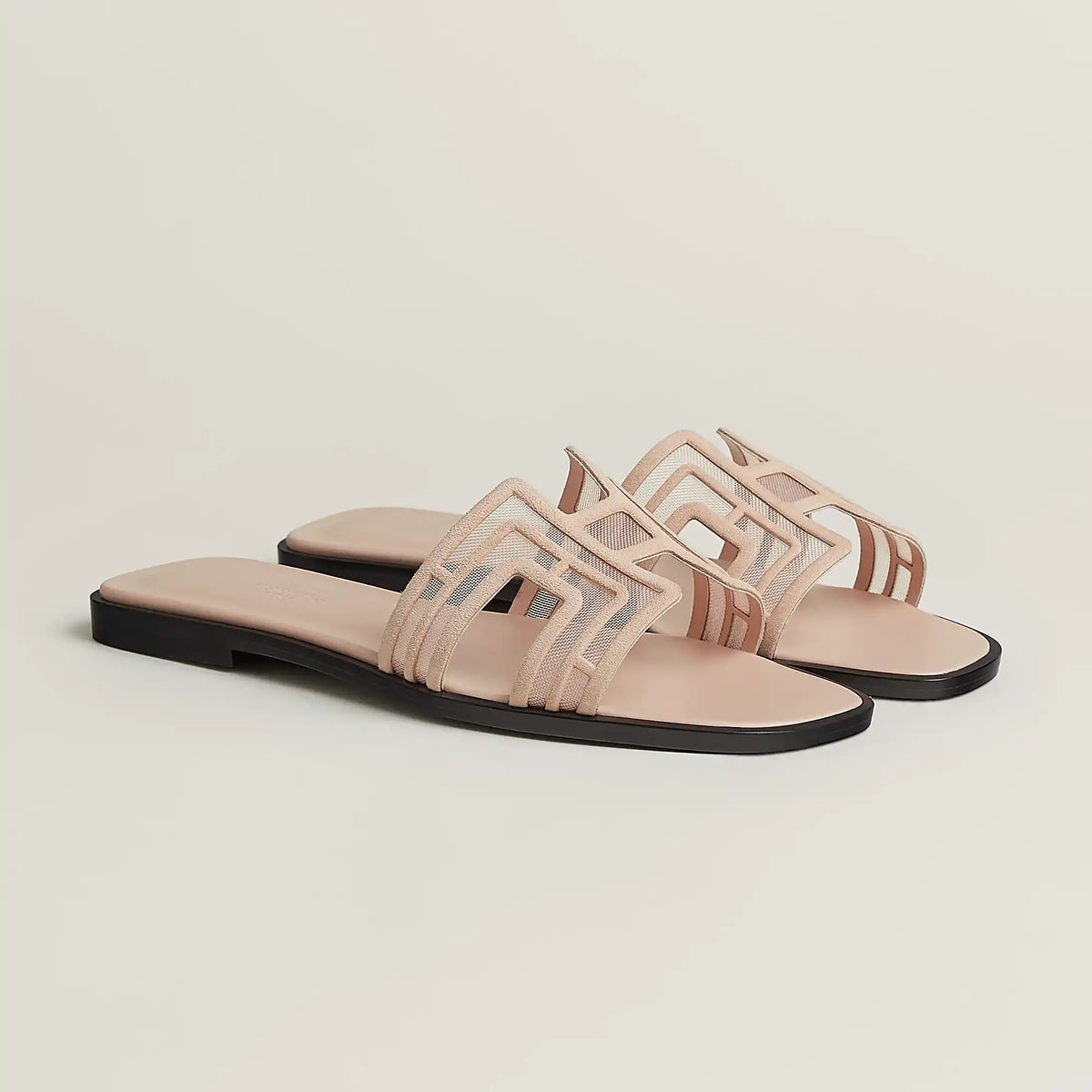 Hermès Oran leather slide sandals in beige, pair with cutout straps