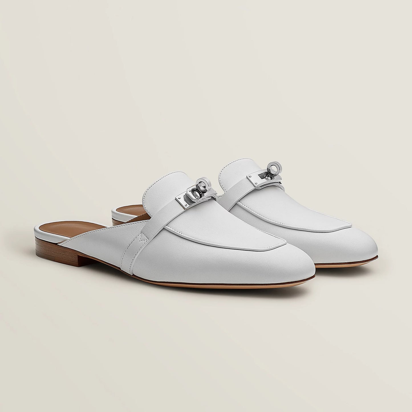White leather mule flats with side buckle strap and low wooden-look heel