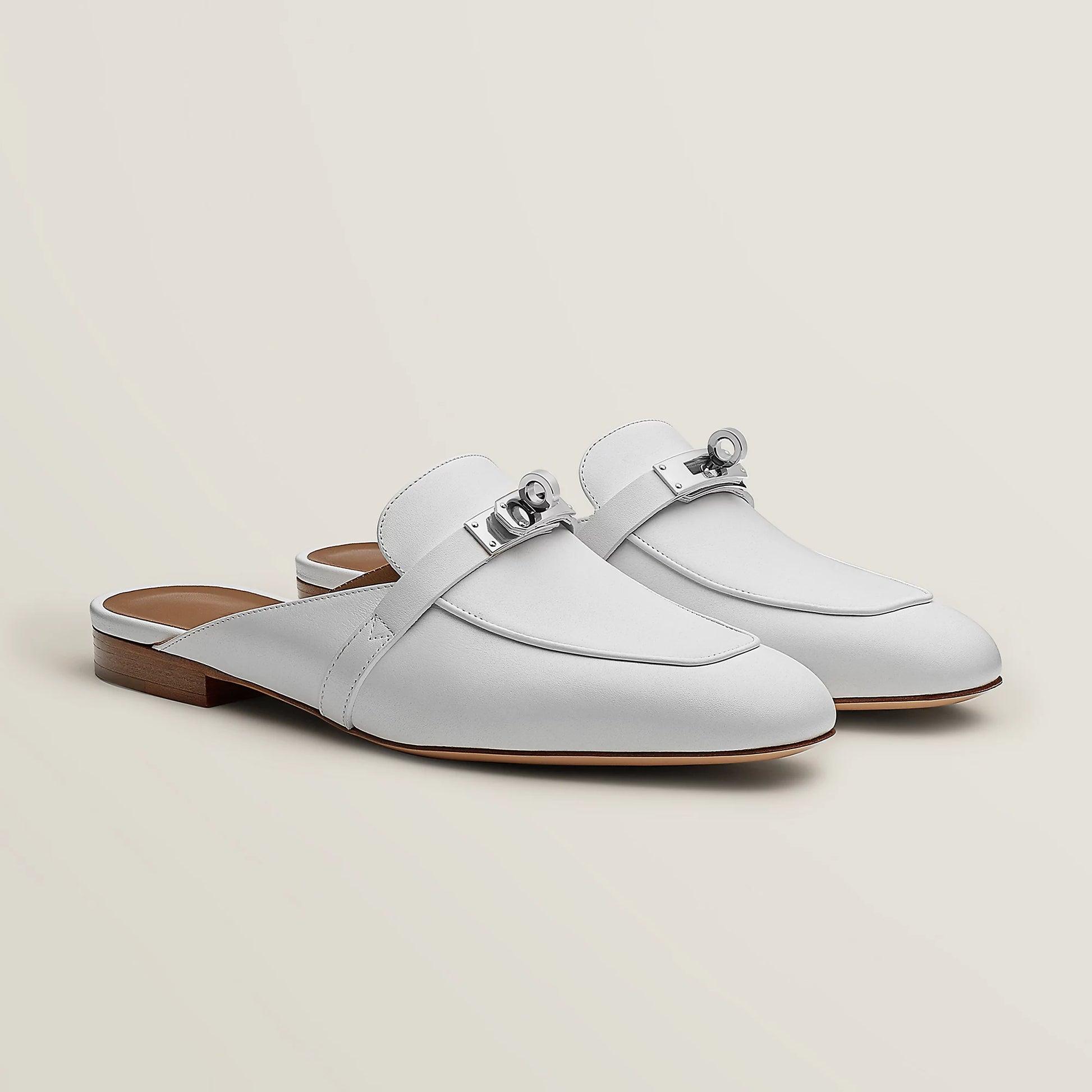 White leather mule flats with side buckle strap and low wooden-look heel