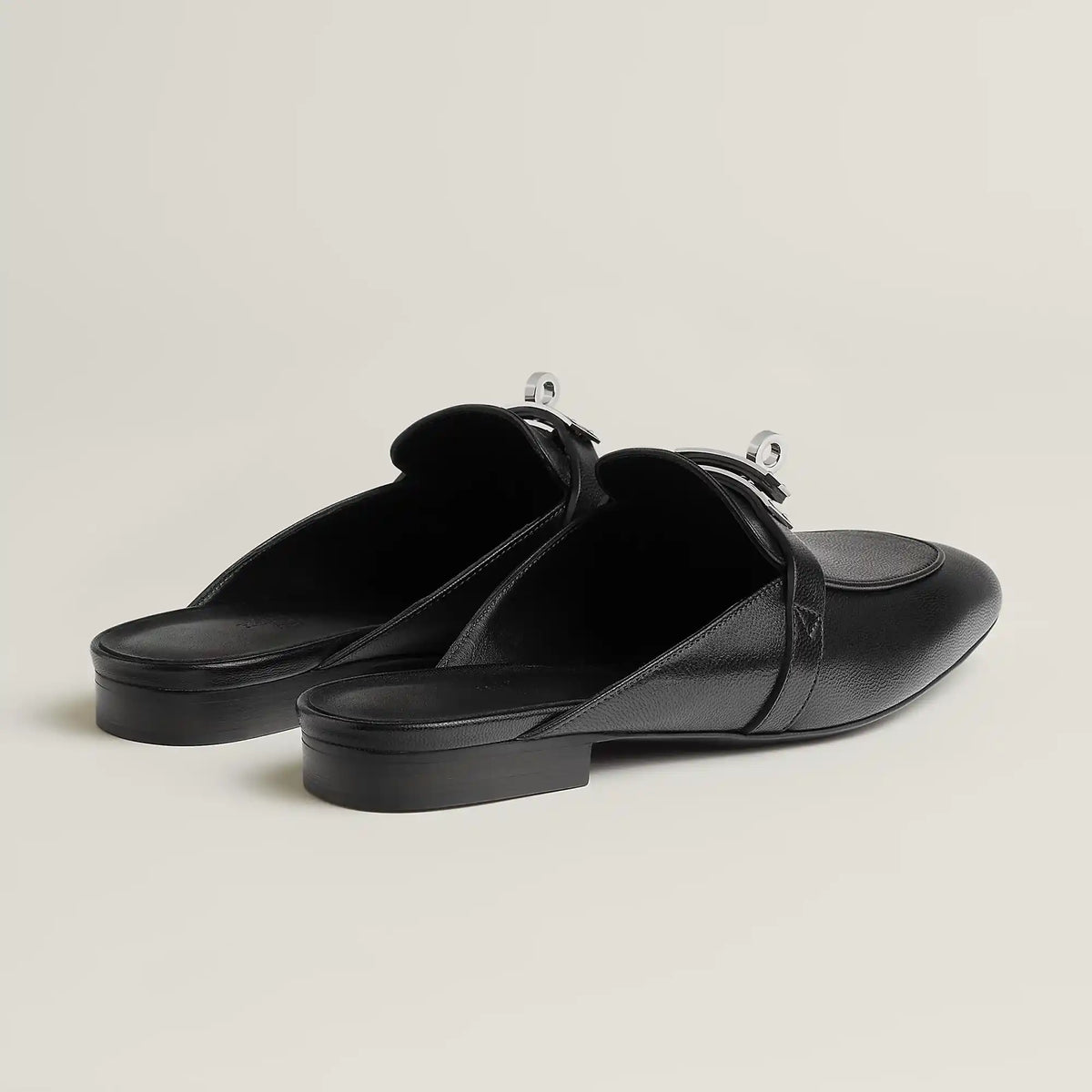 Black leather mule flats with side buckle strap and low flat heel