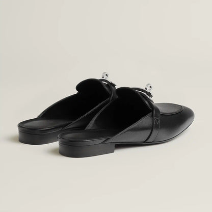 Black leather mule flats with side buckle strap and low flat heel