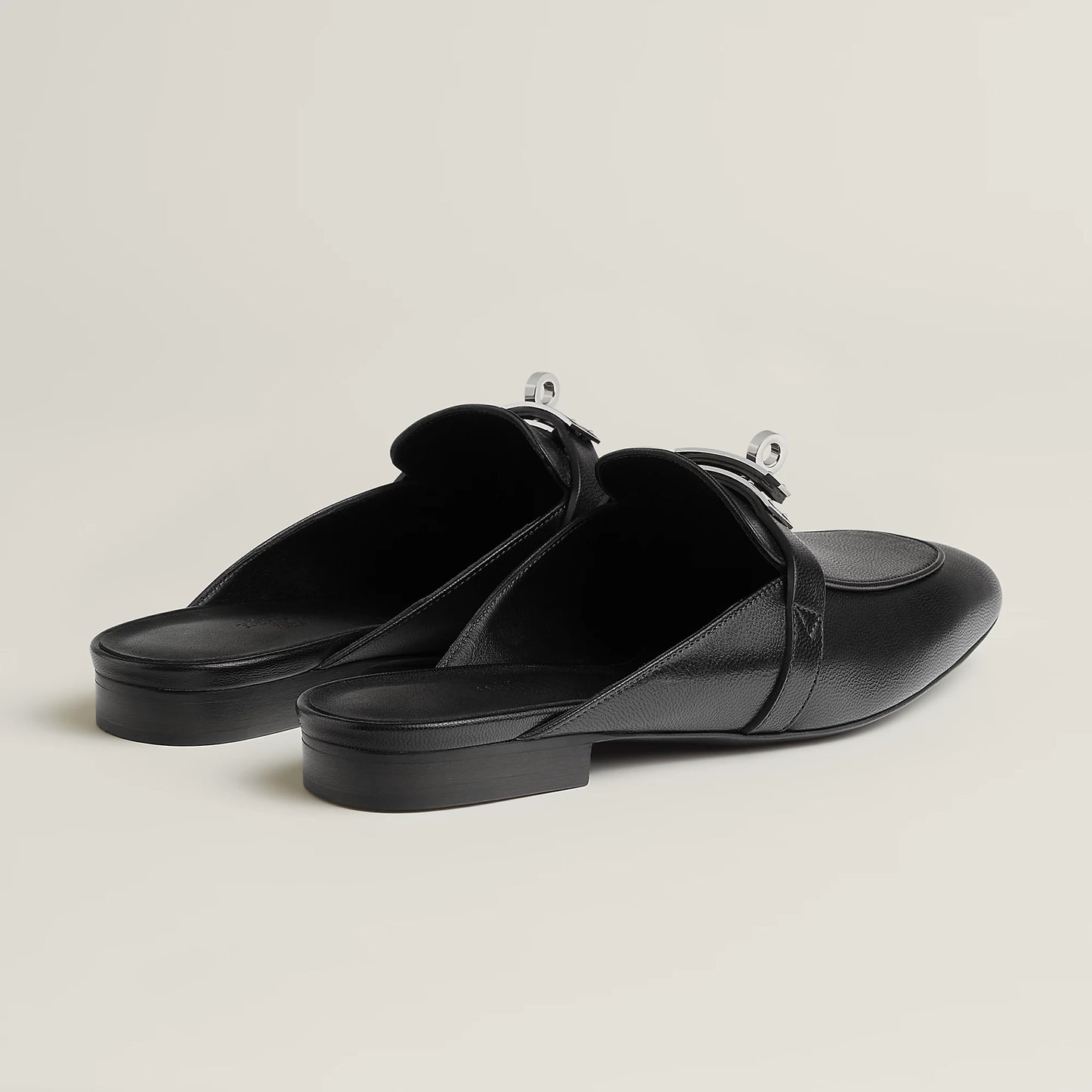 Black leather mule flats with side buckle strap and low flat heel