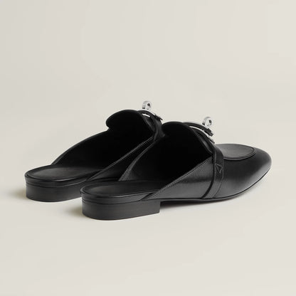 Black leather mule flats with side buckle strap and low flat heel