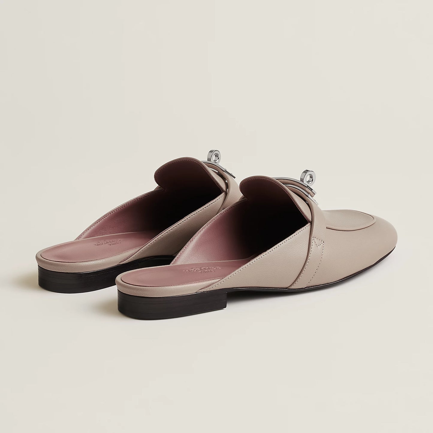 Beige leather mule flats with buckle strap and pink-toned lining
