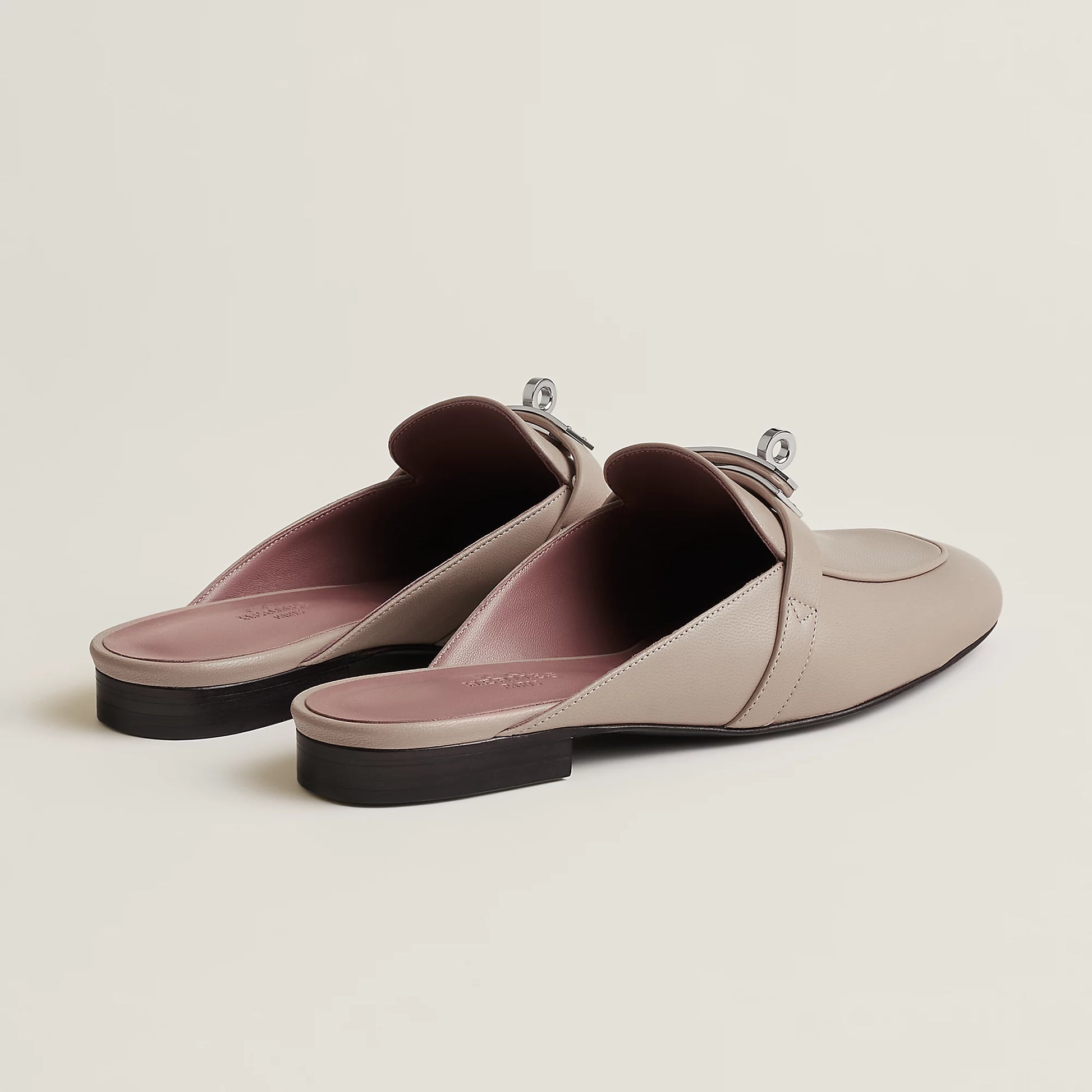 Beige leather mule flats with buckle strap and pink-toned lining