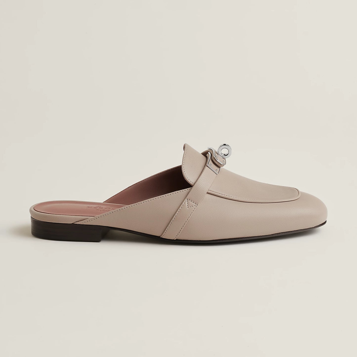 Beige leather mule with buckle strap, open back, and low flat heel