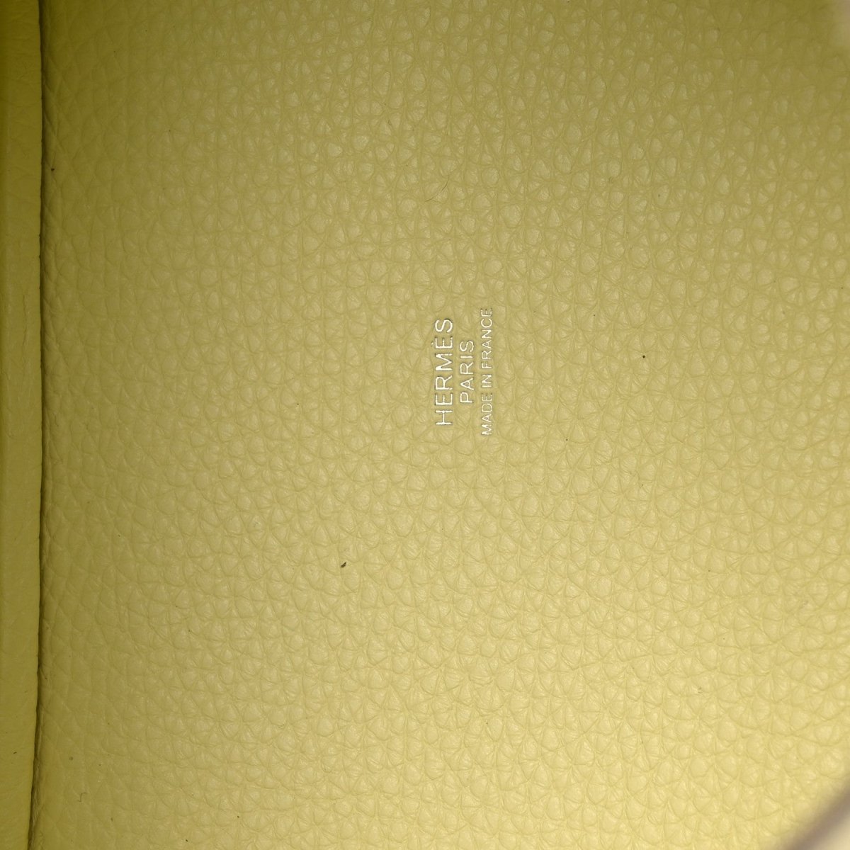 Hermes stamped on yellow leather lining of two-tone handbag.