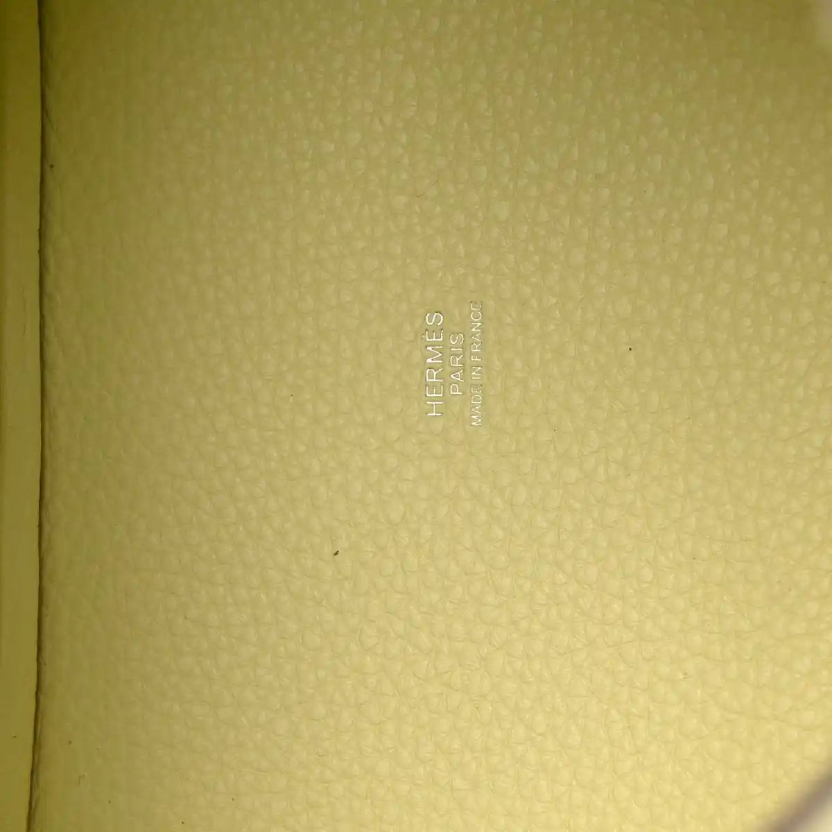 Hermes stamped on yellow leather lining of two-tone handbag.