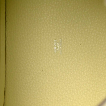 Hermes stamped on yellow leather lining of two-tone handbag.