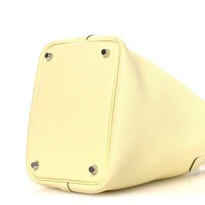 Two-tone leather handbag base in yellow with metal corner tabs and feet.