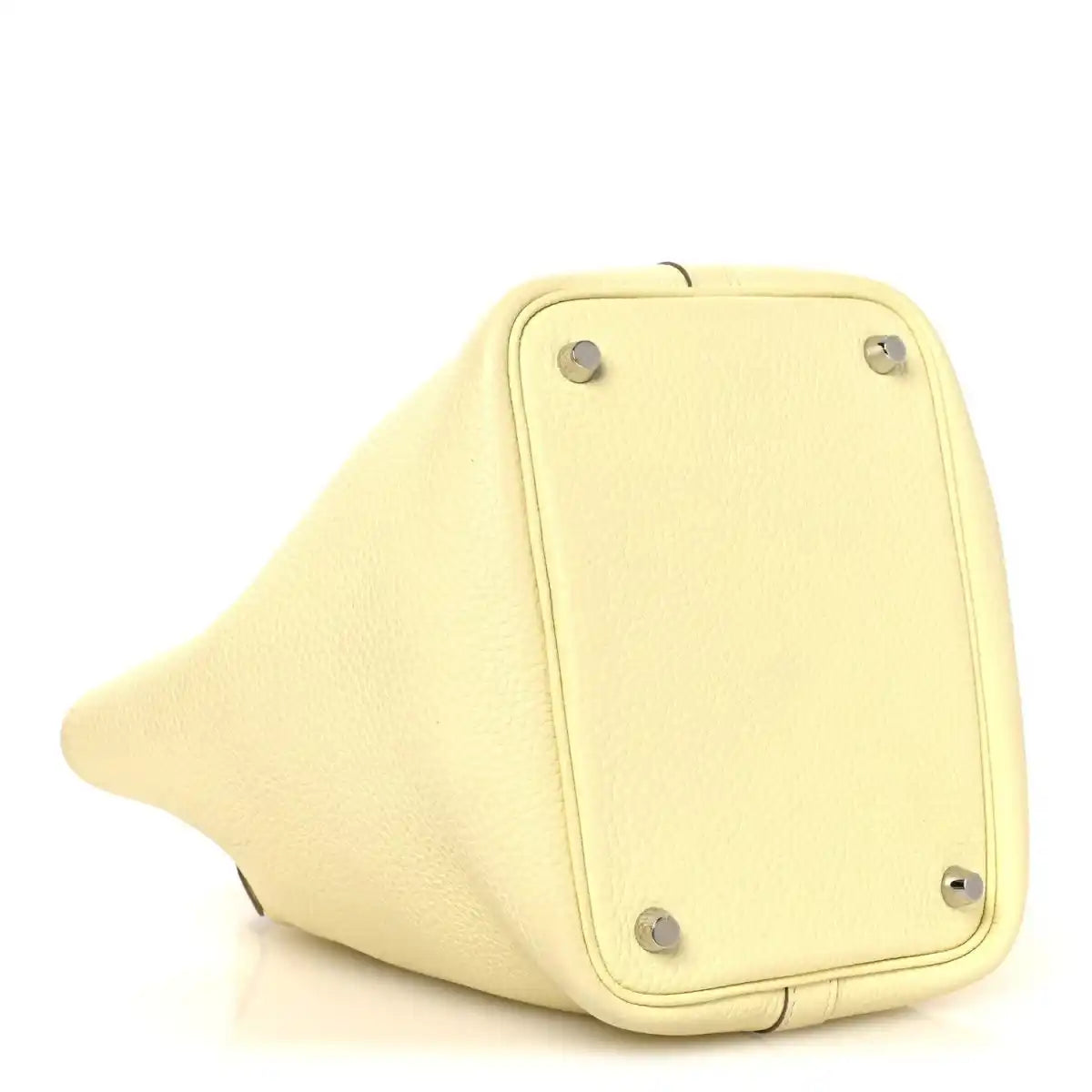 Two-tone leather handbag bottom panel in yellow with metal feet and corner hardware.
