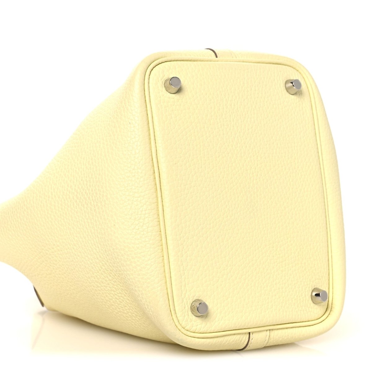 Two-tone leather handbag side panel in yellow with metal corner feet hardware.