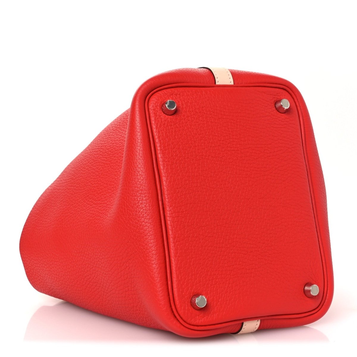 Red pebbled leather mini tote corner view with silver feet and pale trim.