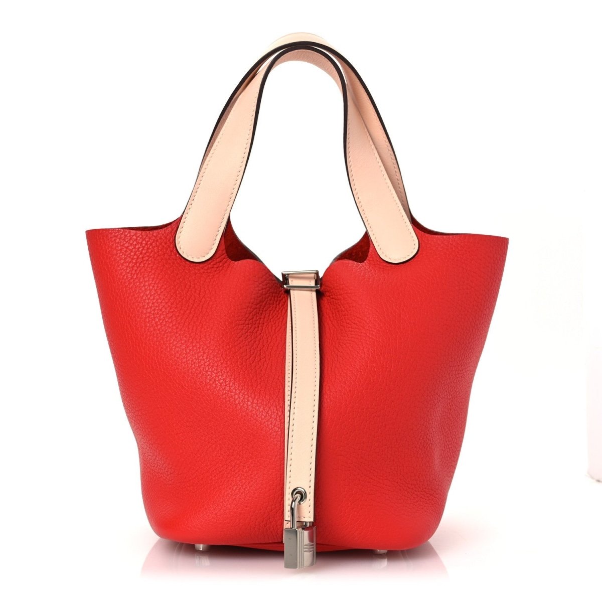 Red pebbled leather tote bag with pale handles and front lock clasp.