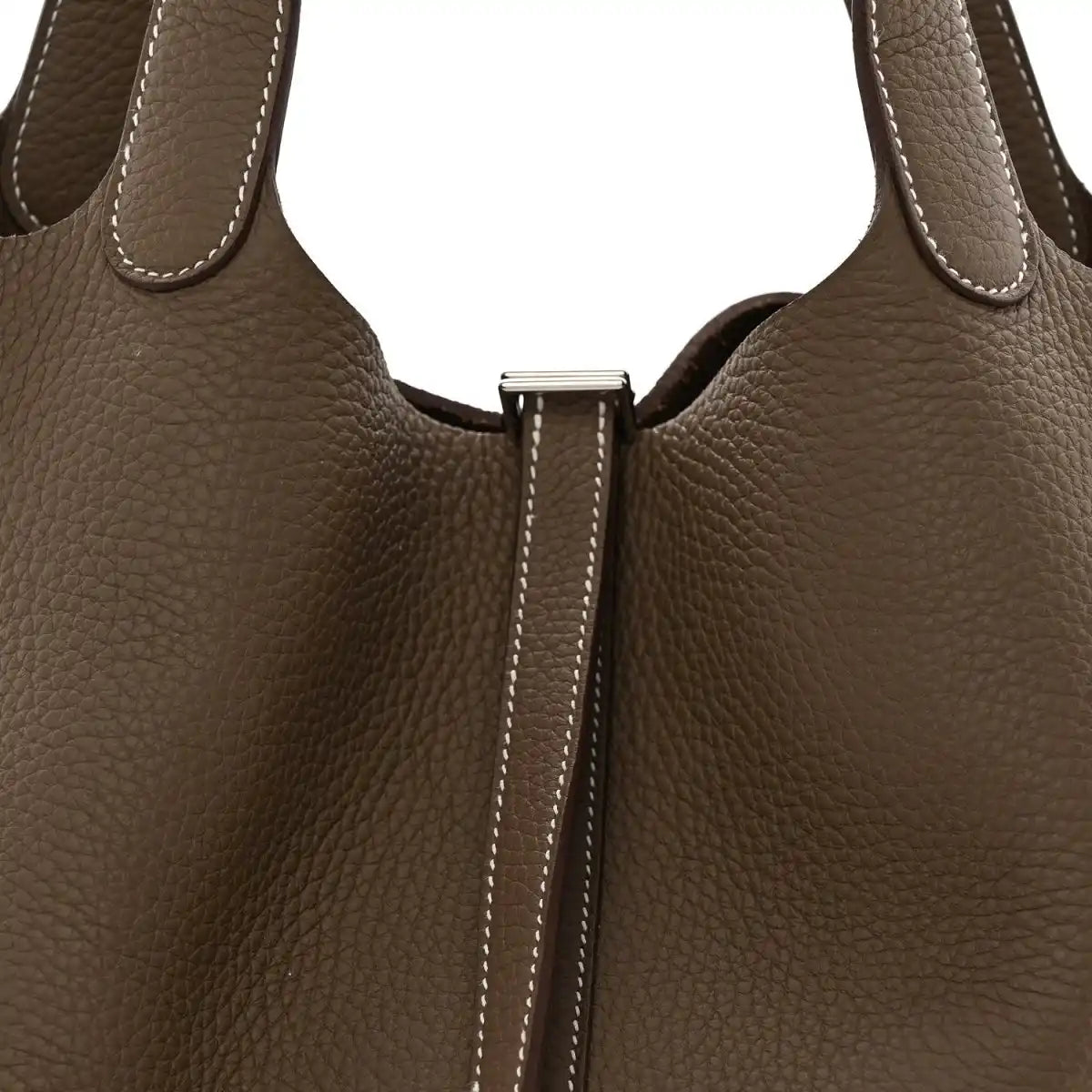 Taupe leather bag front close-up with center lock hardware and contrast edge stitching.