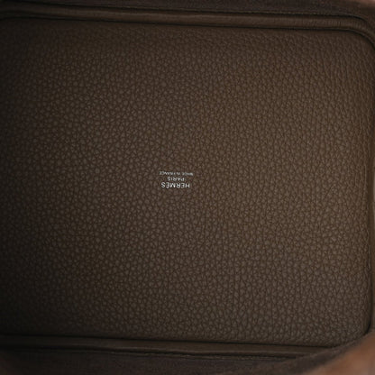 Taupe leather interior panel with embossed brand stamp on textured calfskin.