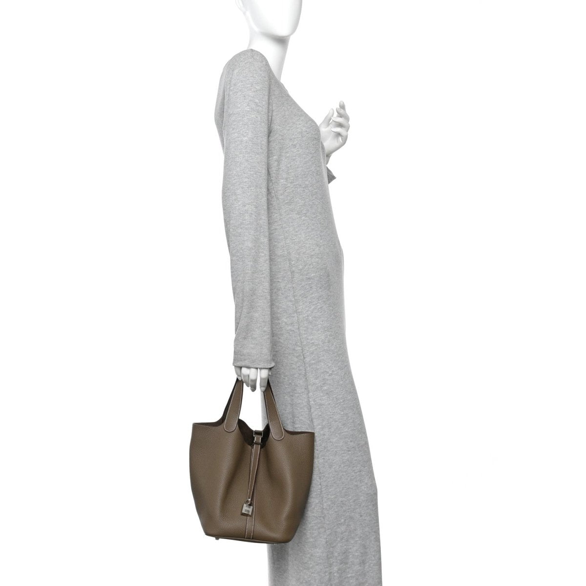 Taupe leather bucket bag with short handles and vertical zip-lock closure.