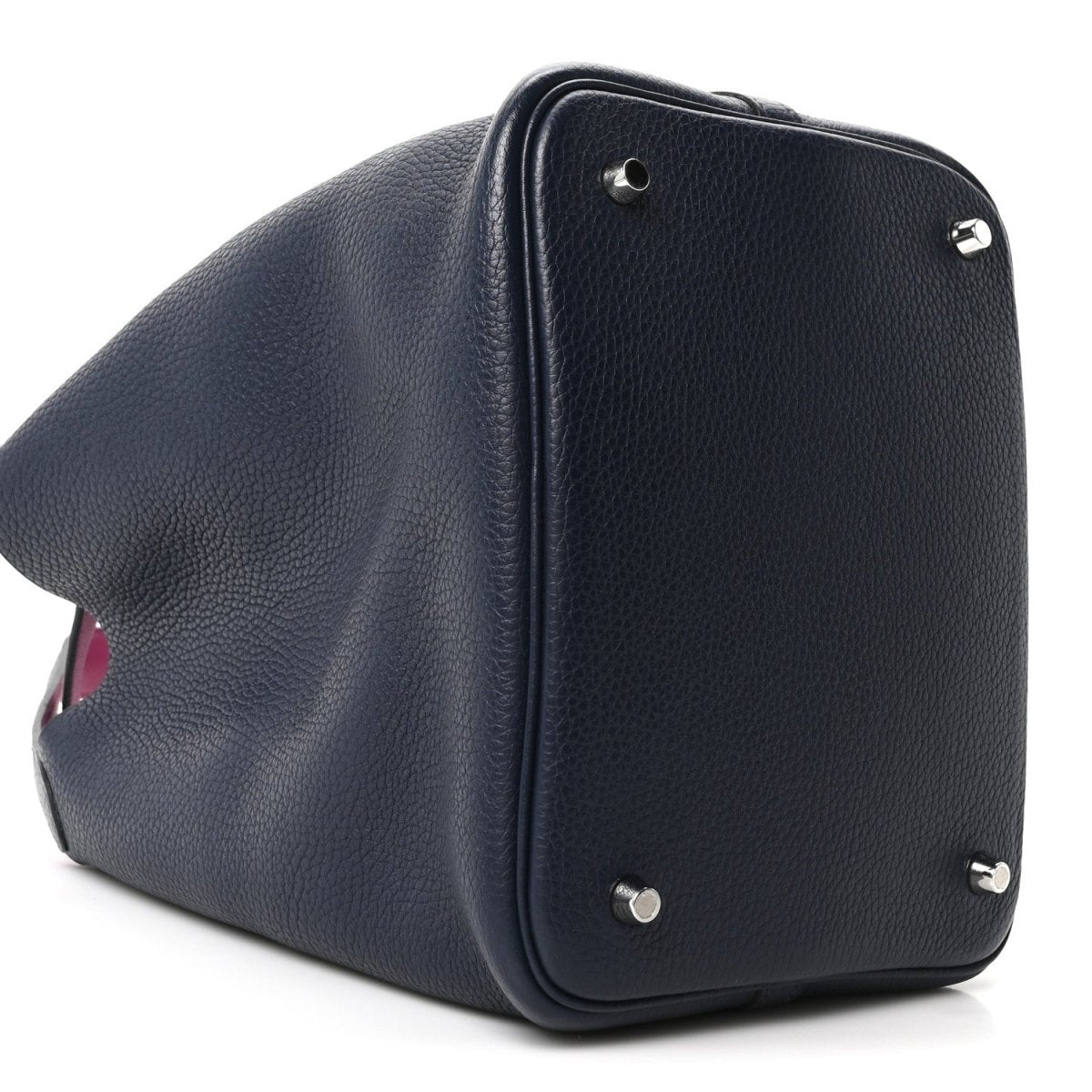 Navy leather bucket bag angled view with magenta lining at opening