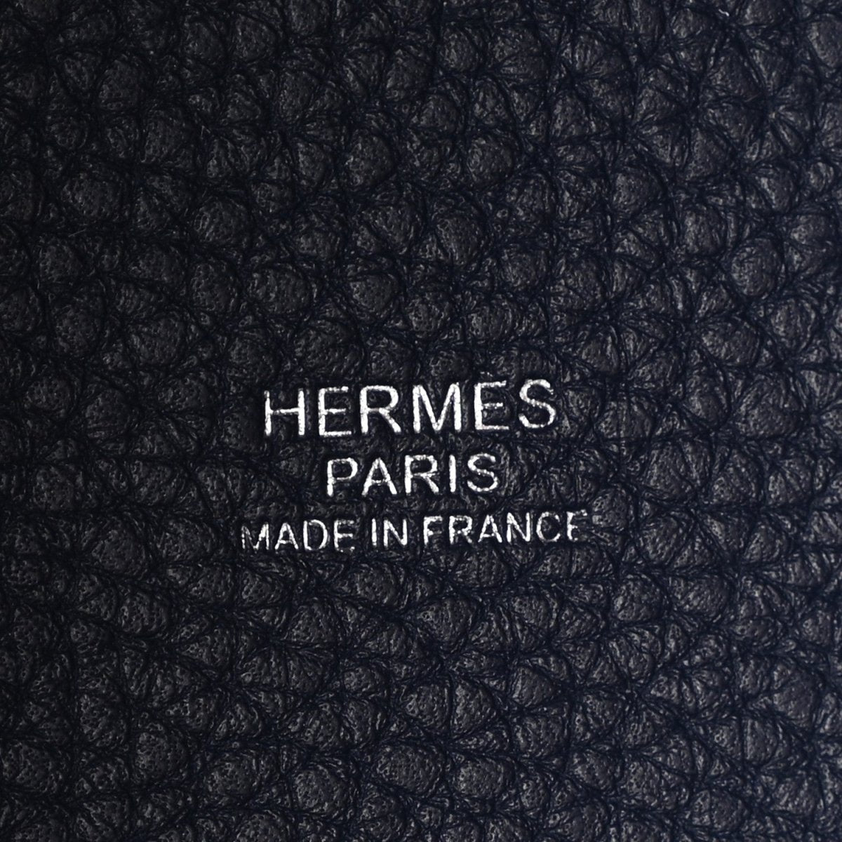 Navy leather close-up with embossed “HERMES PARIS MADE IN FRANCE”