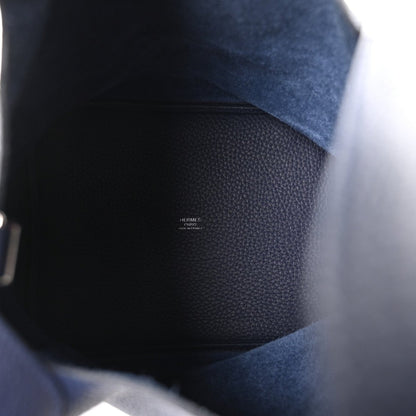 Navy leather bucket bag interior view with small stamped text on lining