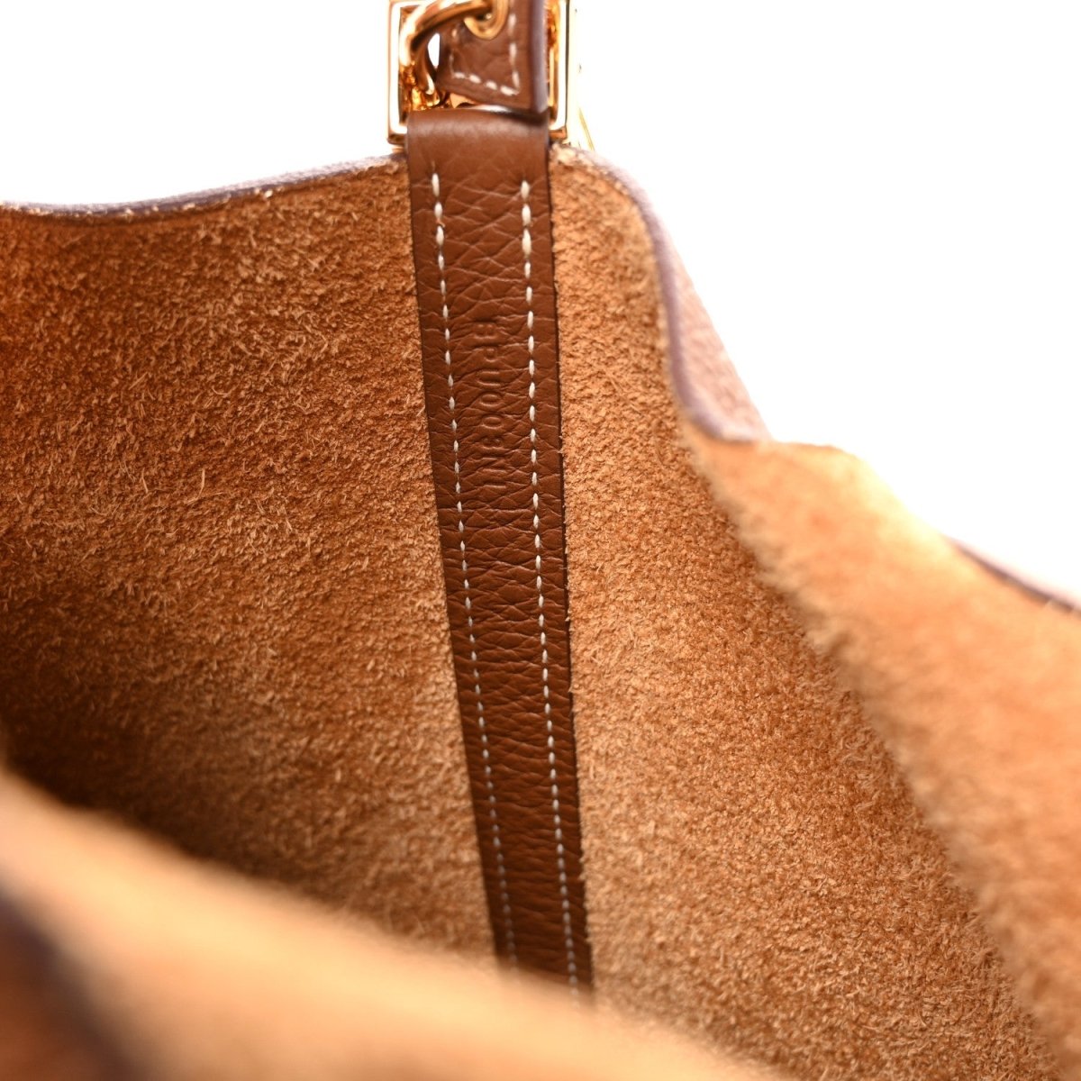 Leather side detail with vertical strap seam and gold-tone metal hardware.