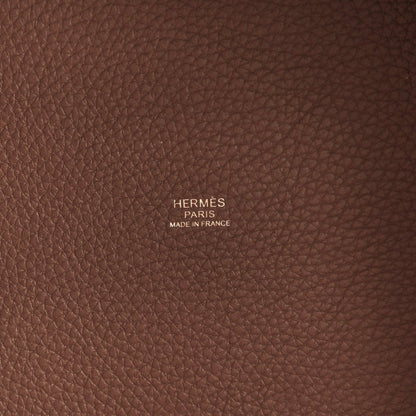 Brown pebbled leather panel with centered Hermes text and Made in France.