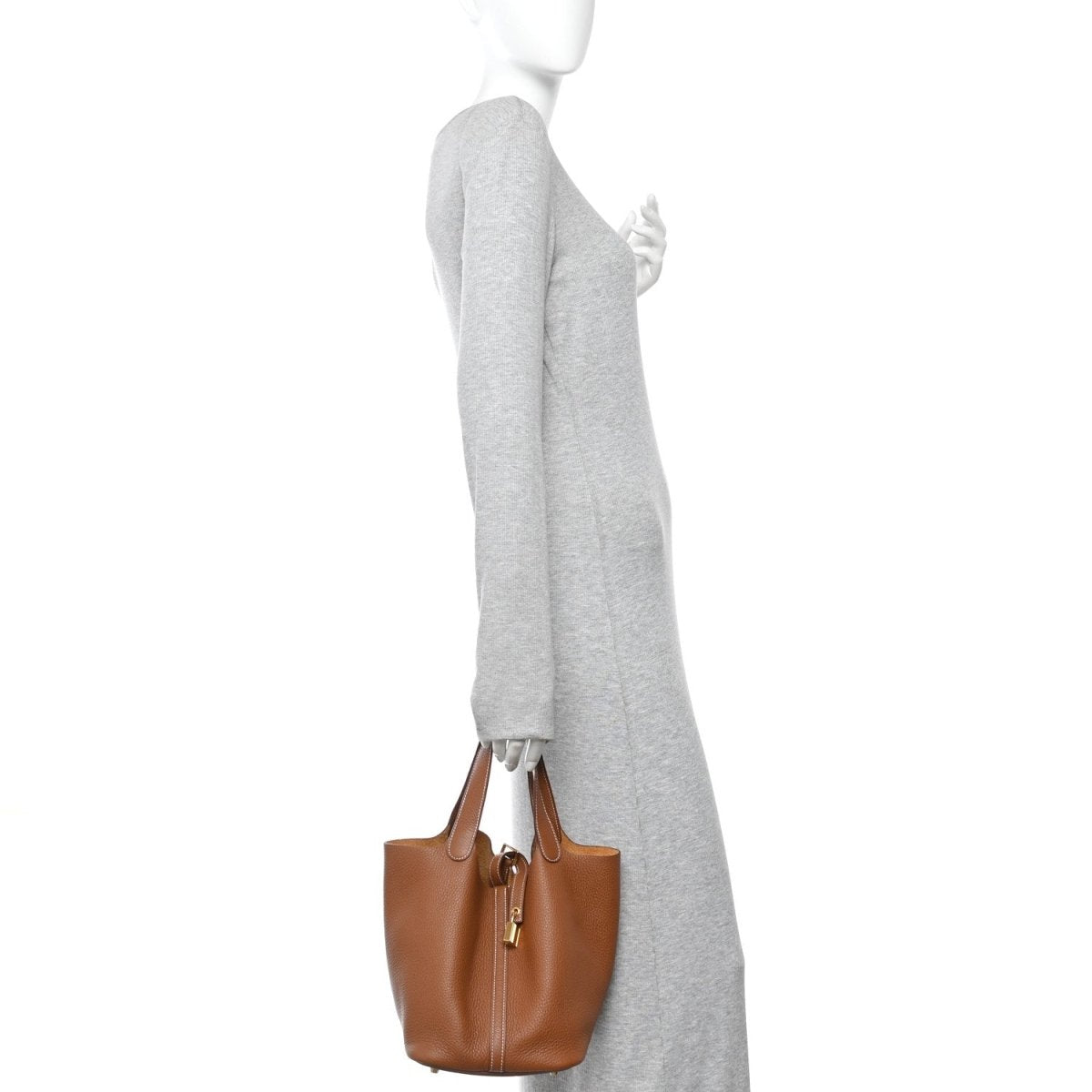 Leather tote bag with top handles and gold-tone lock hardware, brown exterior.