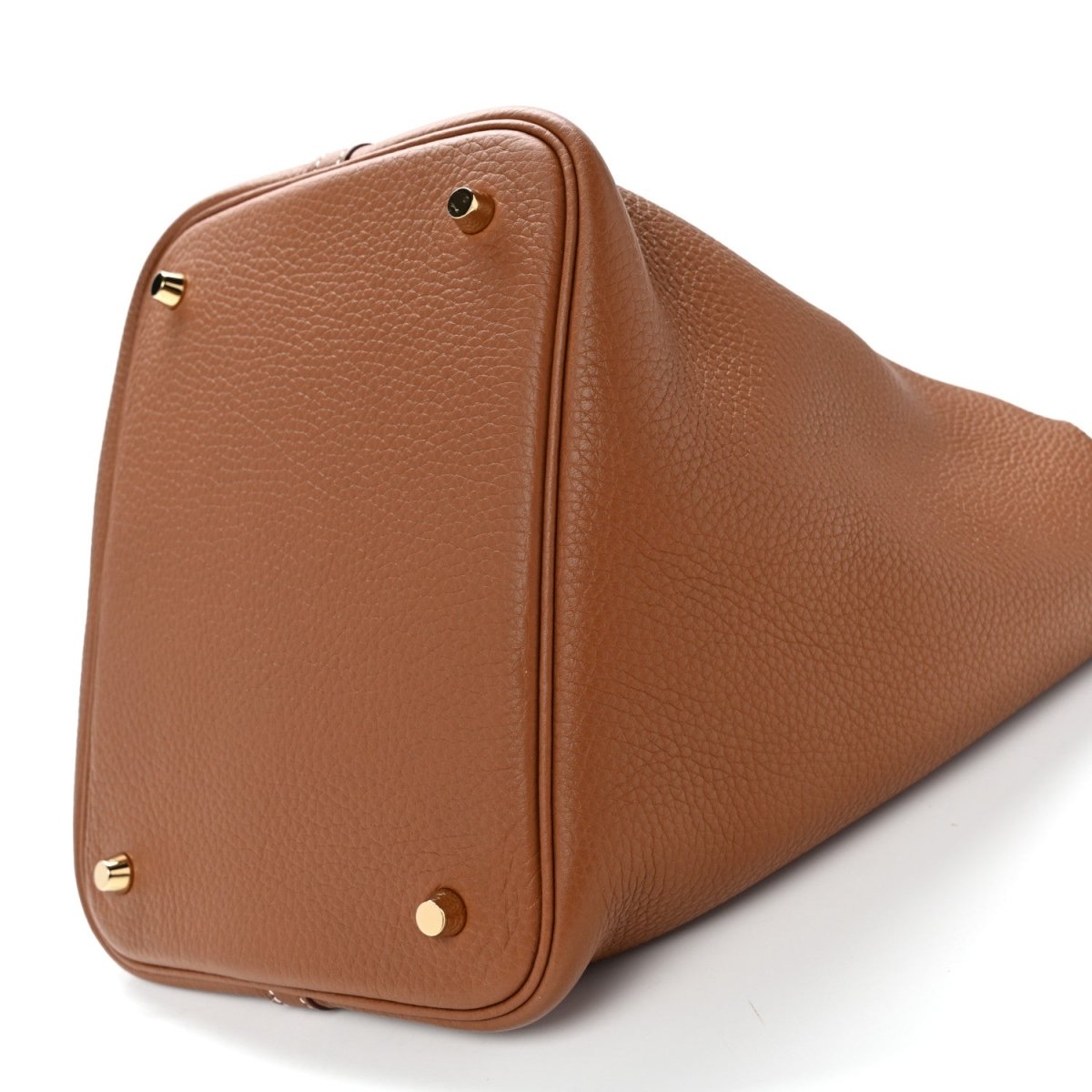 Brown leather tote bag corner view with gold-tone studs and top carry handle.