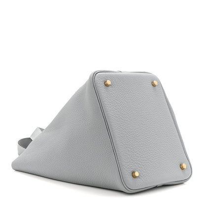 Gris leather tote bag with pebbled texture and gold corner hardware
