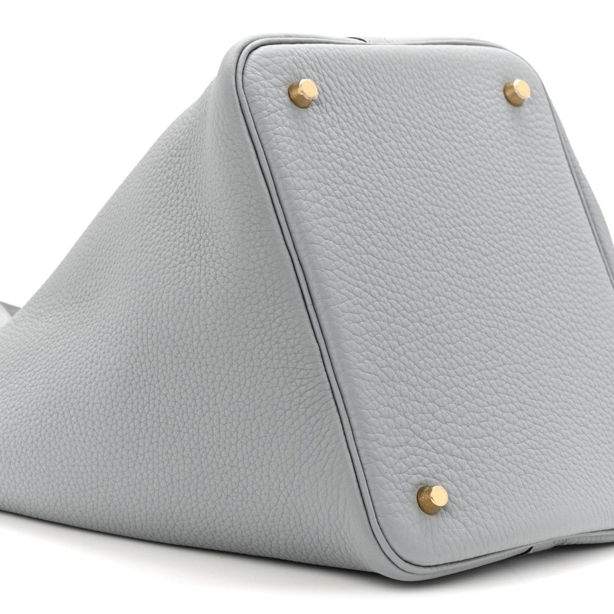 Gris leather tote bag with pebbled texture and gold corner studs