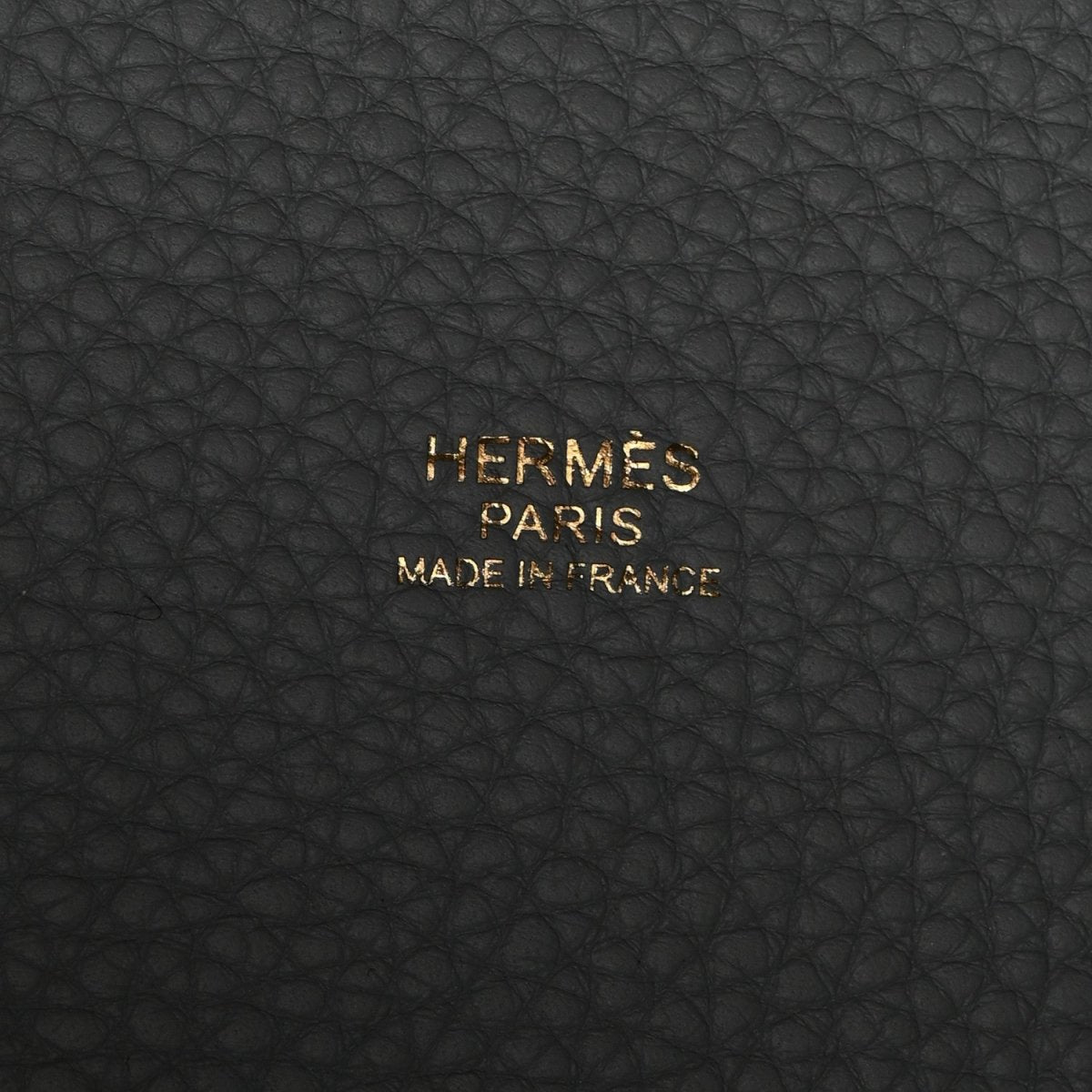 Black leather stamp reading “HERMÈS PARIS MADE IN FRANCE”