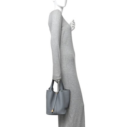 Small gris leather tote bag with short handles and lock clasp, side view