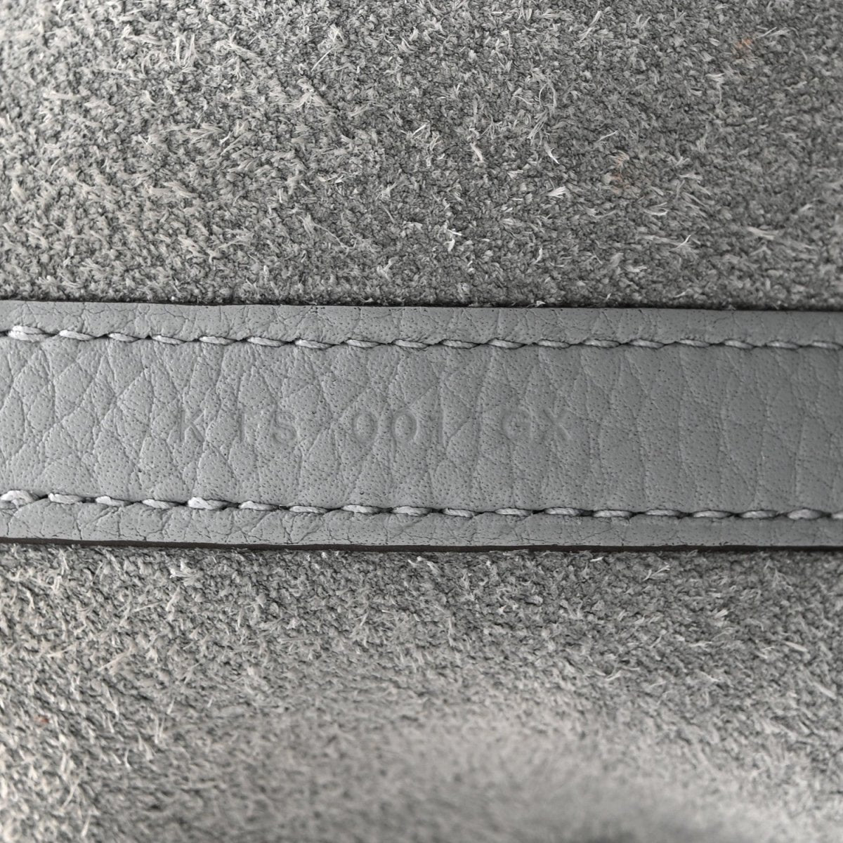 Gris leather edge with visible stitching and seam detail