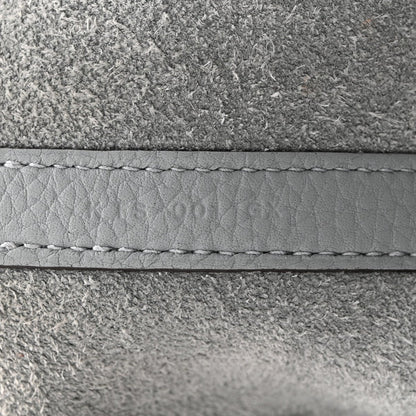 Gris leather edge with visible stitching and seam detail