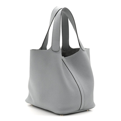 Gris pebbled leather tote bag with curved silhouette and side seam