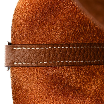 Leather tote bag edge with contrast white stitching on tan trim