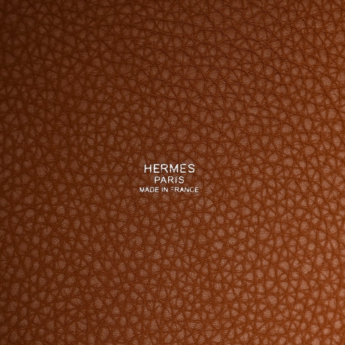 HERMES PARIS made in France embossed on brown leather tote surface