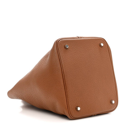 Gold leather tote bag with triangular side panel and silver corner studs